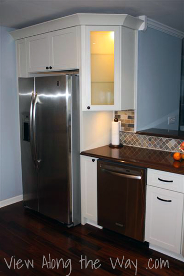 Updated Kitchen with Angled Glass Front Cabinet