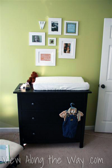 Mini gallery wall in a green boy nursery