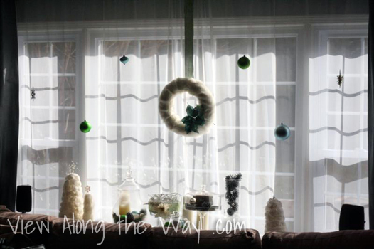 Christmas ornaments hung in a window