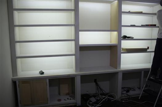 Bookshelves lit with LED reel/strip lights