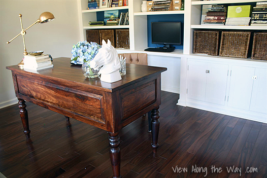 Home office workstation: dark wood desk and white built-in bookshelves, bookshelf, shelving unit