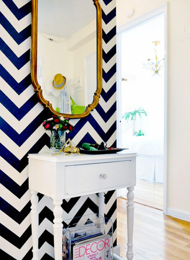 Wall stenciled with navy and white chevron stripes