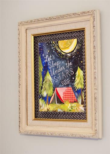Tape a print to the wall with washi tape and frame it with a thrift store frame
