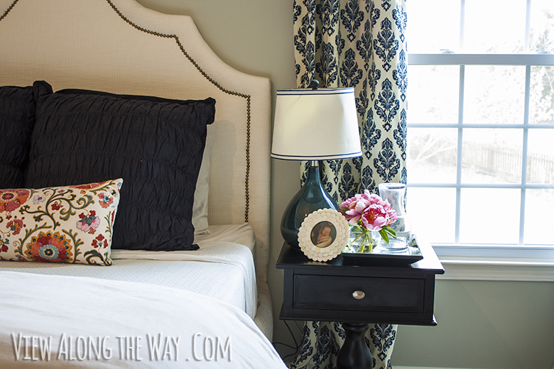 Styled nightstand, DIY upholstered bed and DIY curtains at View Along the Way