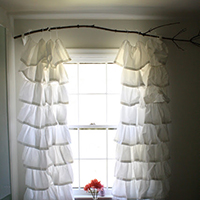 Hang curtains from a branch - and LOTS of other creative, inexpensive curtain rod ideas!