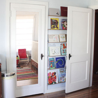Make front-facing bookshelves for the lost space behind the door - and come check out the other creative storage and wall decor ideas at this link!