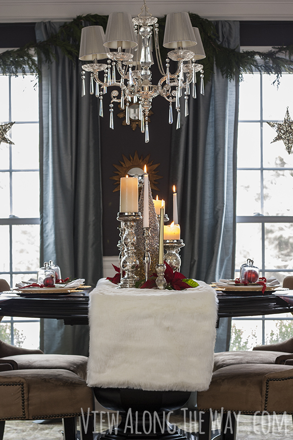 Dining room decorated for Christmas with candles and a fur runner