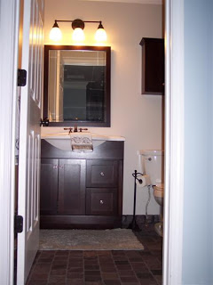 bathroom dark wood vanity and mirror