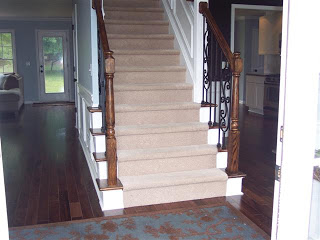 upgraded foyer dark hardwoods, iron ballusters