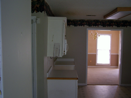 Kitchen Before: Border, White Laminate Cabinets, Vinyl Floors 3