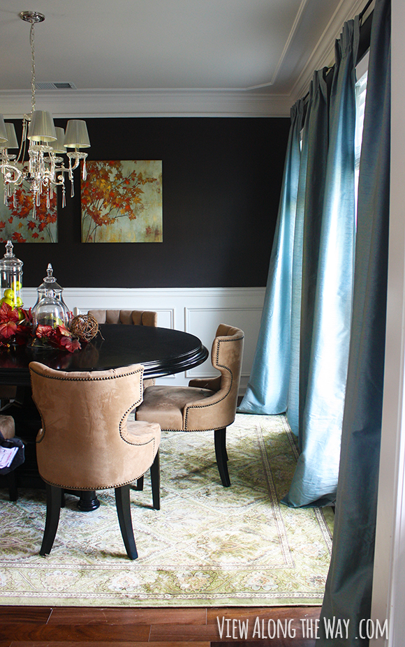 Dining room with dark walls, crown molding and chair rail at www.viewalongtheway.com