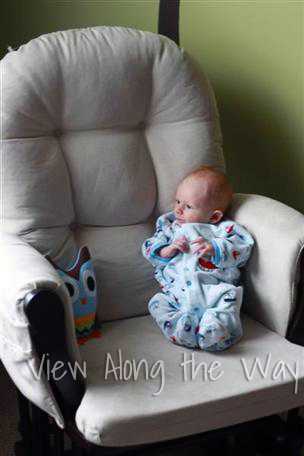 Baby Boy in Glider with Stuffed Owl