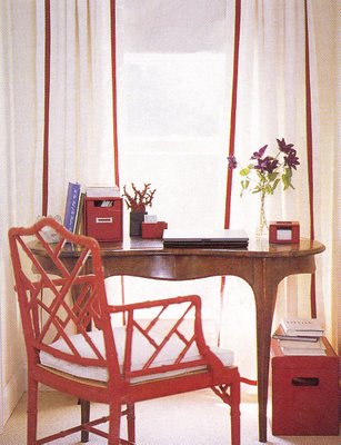 Red chinese chippendale chair at a desk