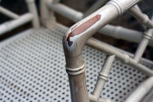 Chipped, faded paint on a vintage chinese chippendale chair