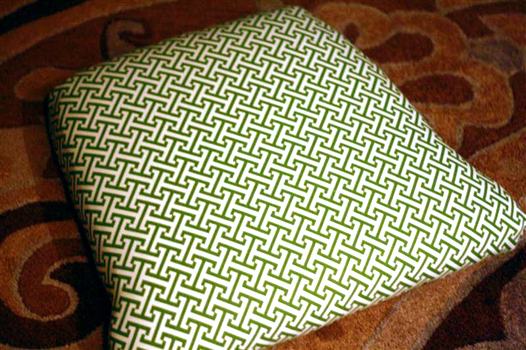 Green and white fabric upholstered seat on antique furniture
