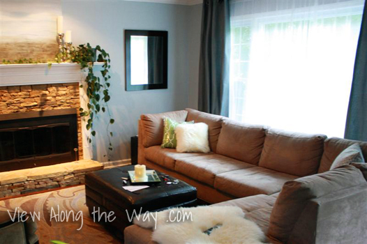 Living room: tan sectional, fireplace