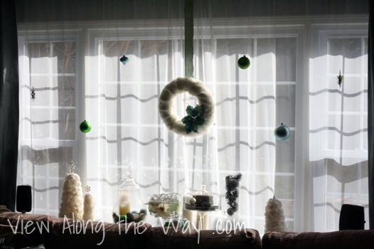 Christmas ornaments hung in a window Christmas ornaments hung in a window