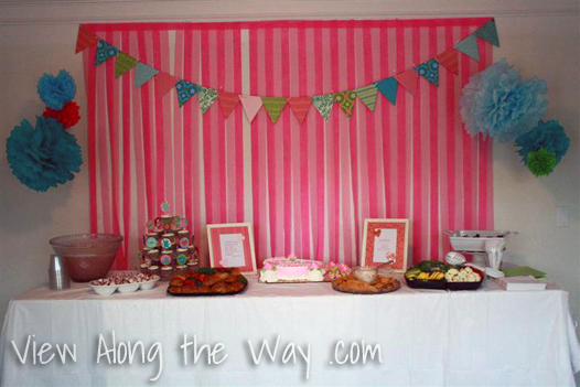 Strips of crepe paper behind the food table at a baby shower or birthday party, shower decoration ideas, baby shower decorations, baby shower decoration ideas