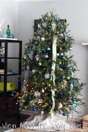 Christmas Tree with blue and green ornaments, silvery ribbon and decorations