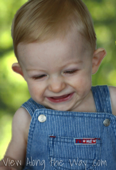 Smiling baby in overalls