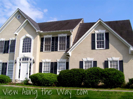 House Exterior: Beige with Black shutters and black roof