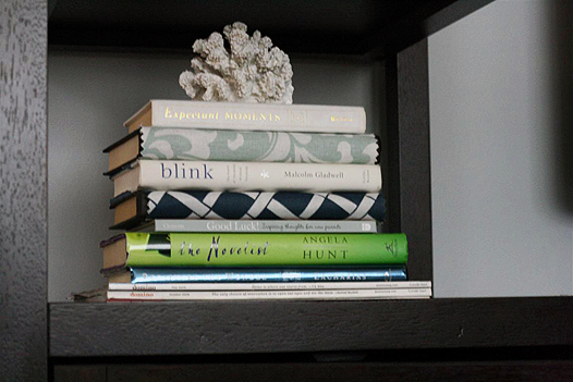 Decorating with books: stack of books with coral 