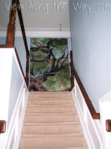 Oversized art piece at the top of stairs