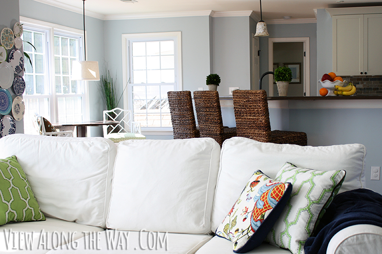 White sofa, breakfast nook and wicker barstools