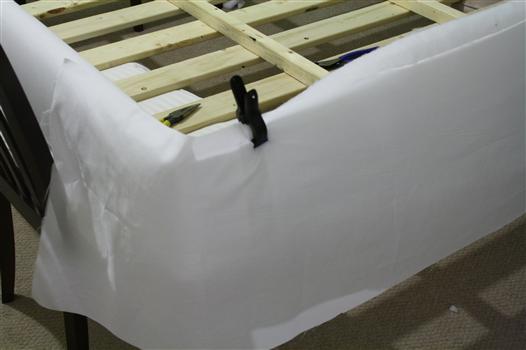 covering the corners of a queen bed in fabric