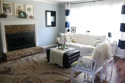 Living room: white sofas, navy and white striped curtains