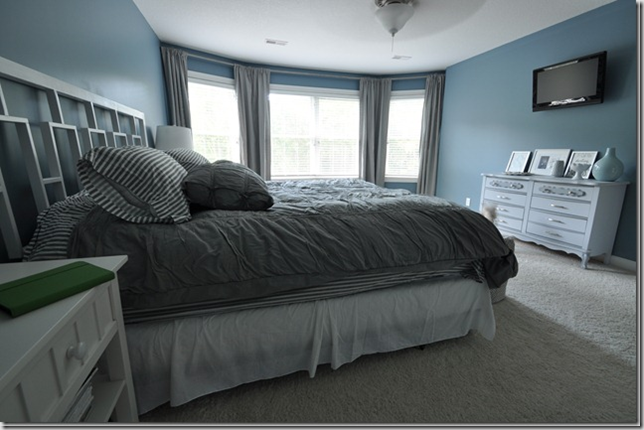 blue bedroom with white west elm headboard