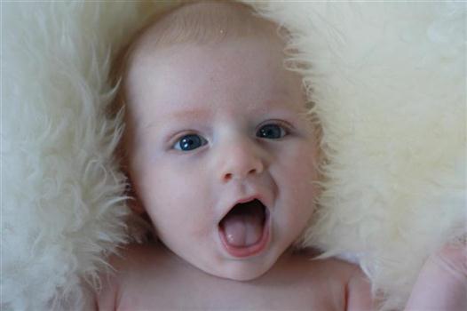 Baby on a sheepskin rug