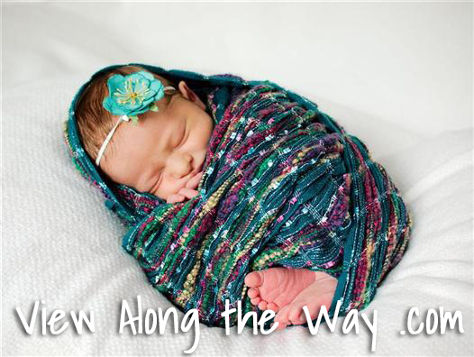 Professional baby photo in turquoise scarf