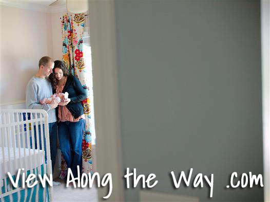 Holding Newborn in a nursery