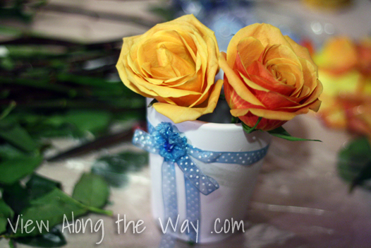 Filling a vase with orange roses