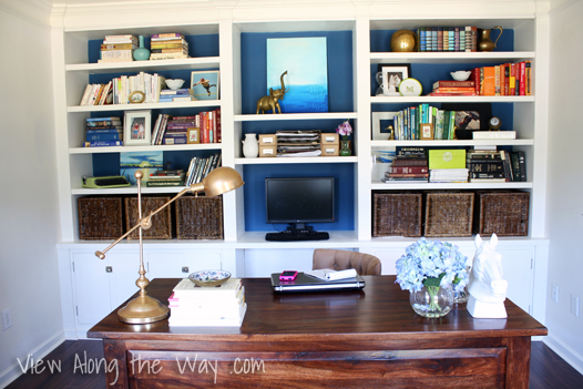 Office: turquoise built-n shelves and dark wood desk
