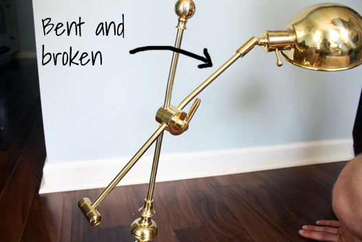 Shiny brass task lamp with broken leg