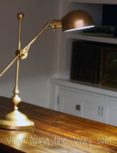 Bronze task lamp lit at night