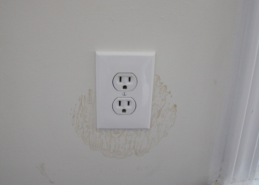 stained wall around receptacle