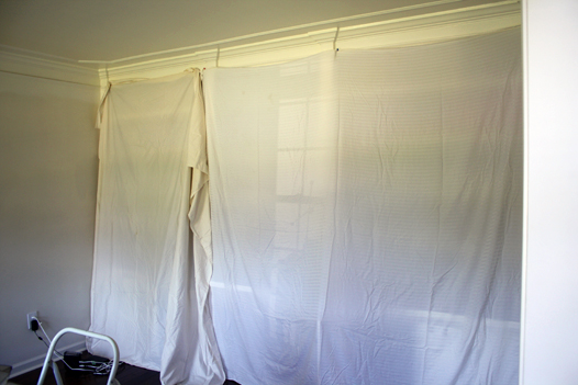 Bookshelves covered in sheets