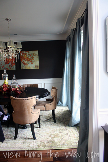 Dark brown dining room decorated for autumn