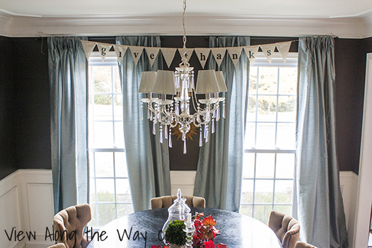 Dining room with white chair rail and Benjamin Moore warm caviar walls