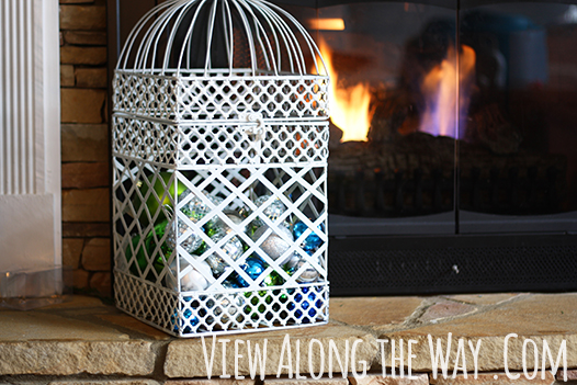 Use a birdcage to display christmas ornaments