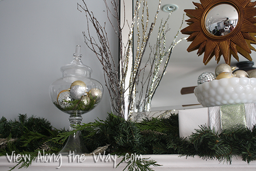 Glittery Branches in a Vase with Apothecary Jar and Metallic Ornaments on a Christmas Mantel