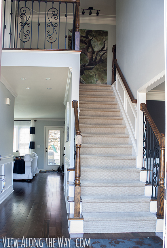 Foyer with dark hardwoods and white trim