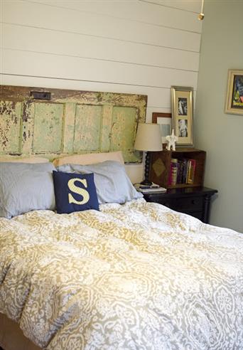 Planked bedroom wall, salvaged door headboard