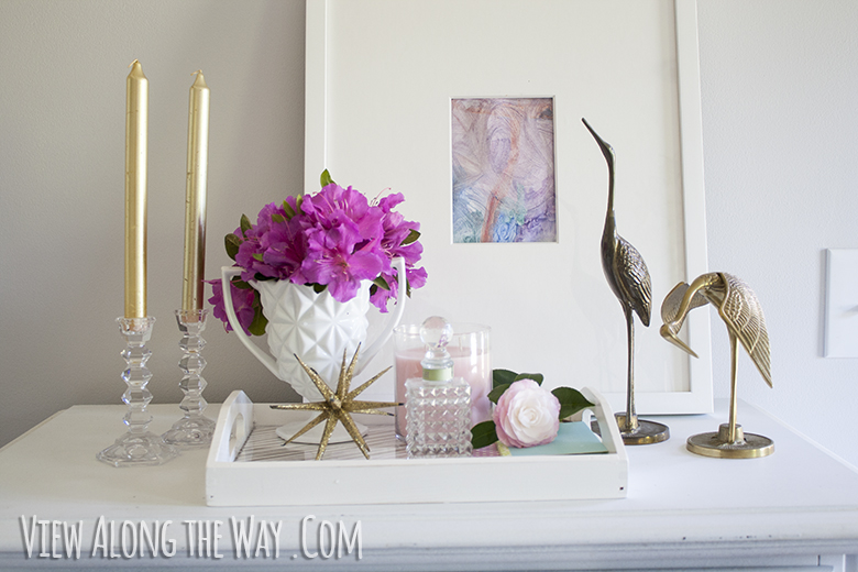 Styled vanity tray with art, gold/brass and pink