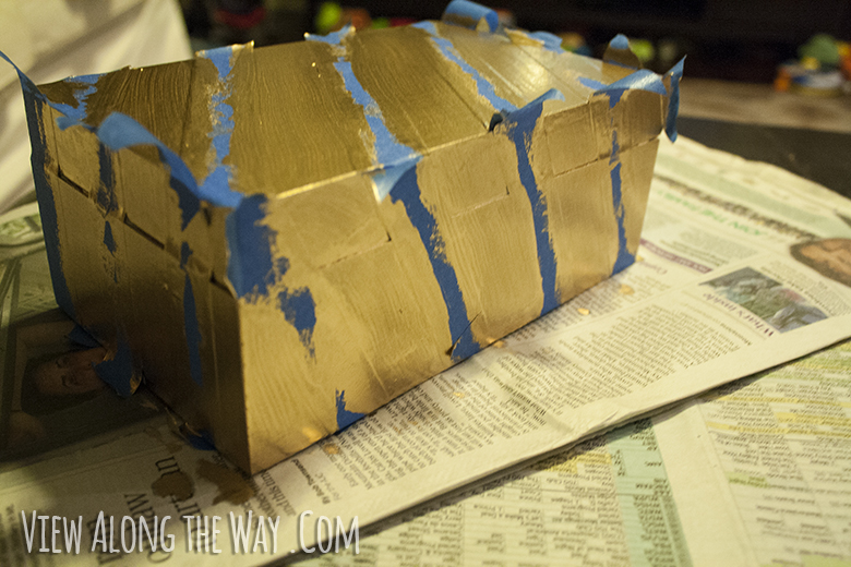 Gold box with painters tape stripes