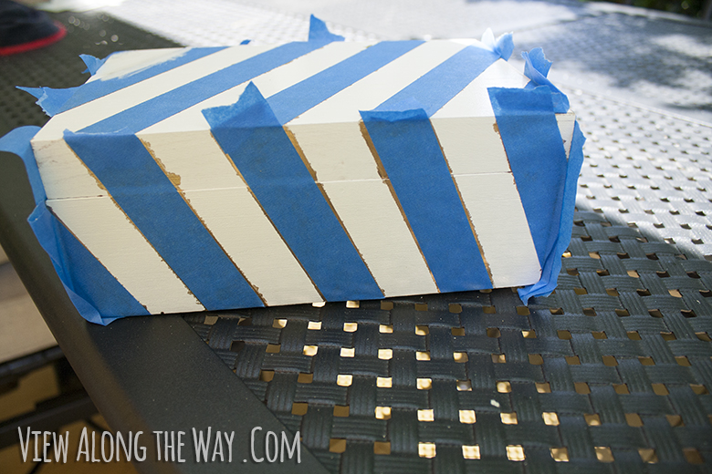 Box with taped diagonal stripes