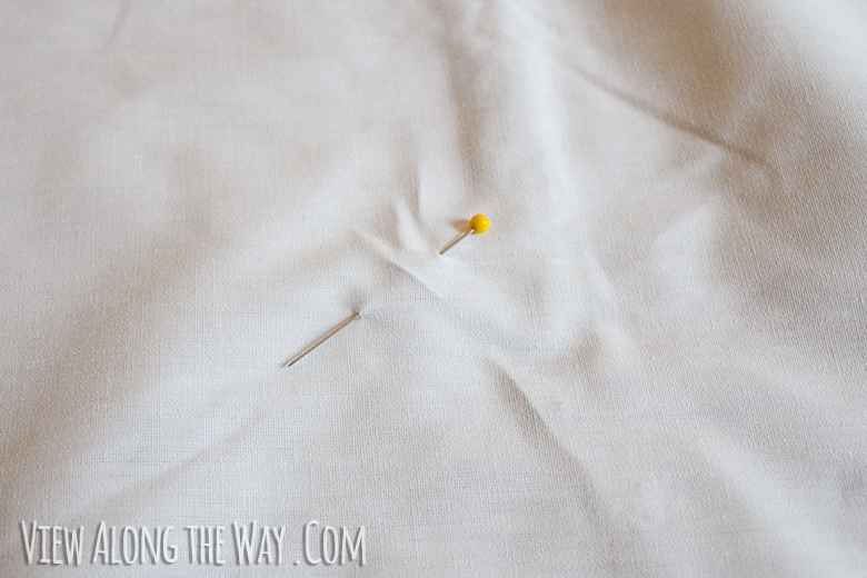 Yellow pin in white sheet